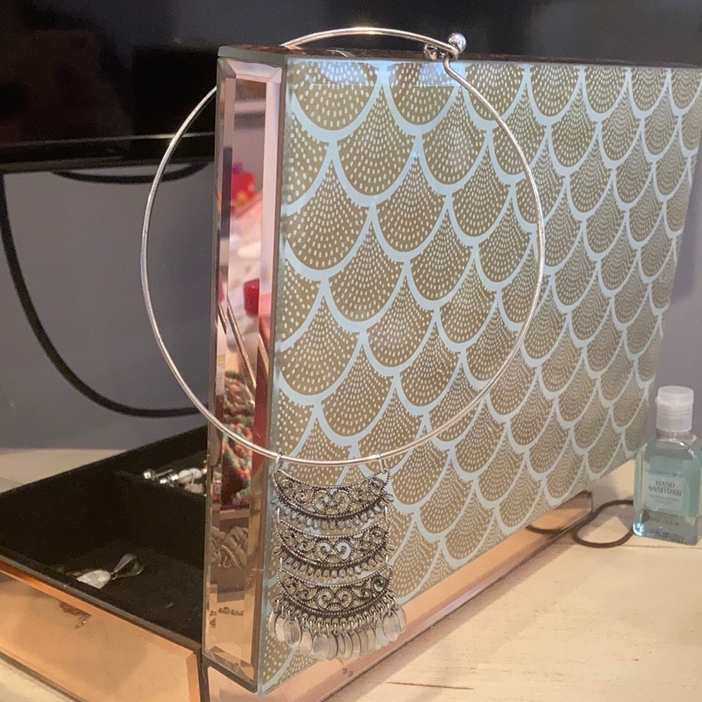 A silver necklace with Indian design